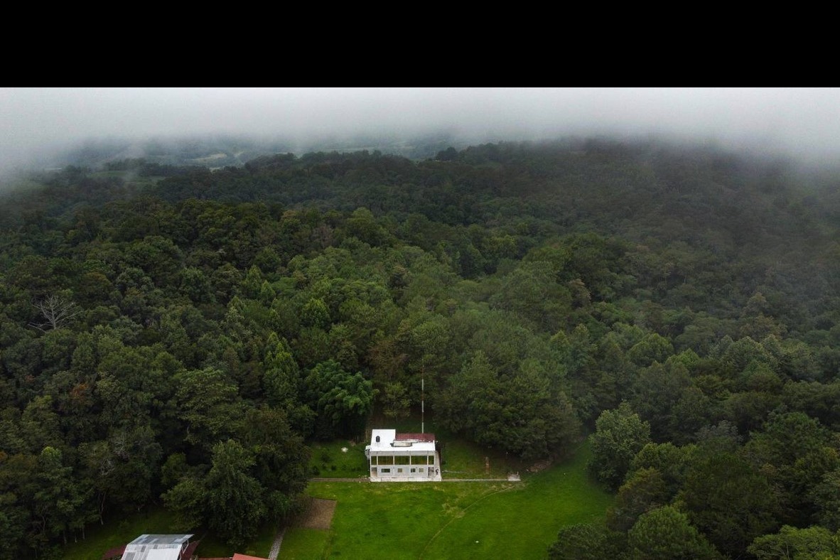 Vista aérea del monasterio Dhamma Vihāra entre la niebla, Jilotepec, Veracruz